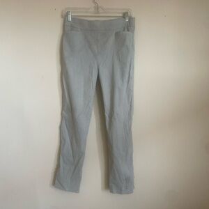 Grey and white pinstripe trousers with a zip fly and button closure,